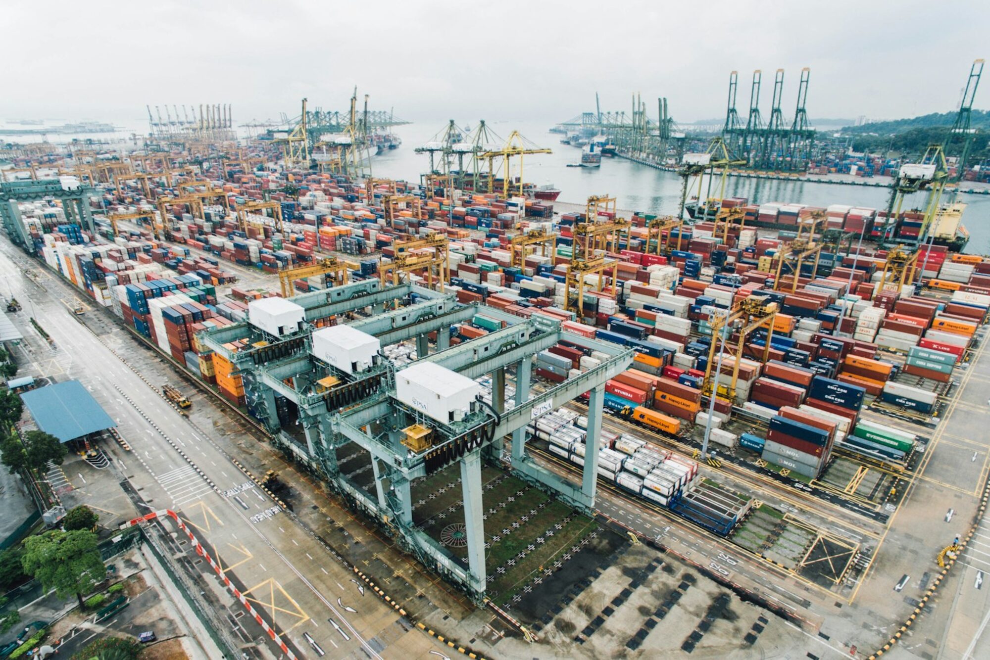 Aerial view of a container terminal with gantry cranes and stacked containers
